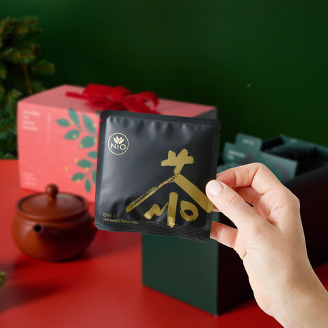 Hand taking a tea sachet out of the advent calendar